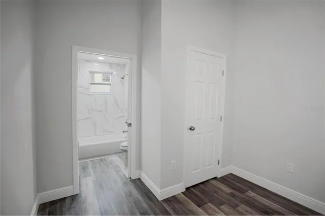 a view of a room with wooden floor and a sink