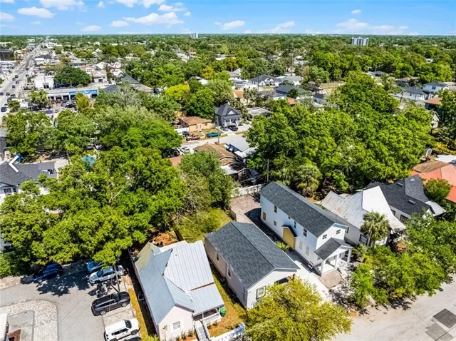an aerial view of a house with a yard
