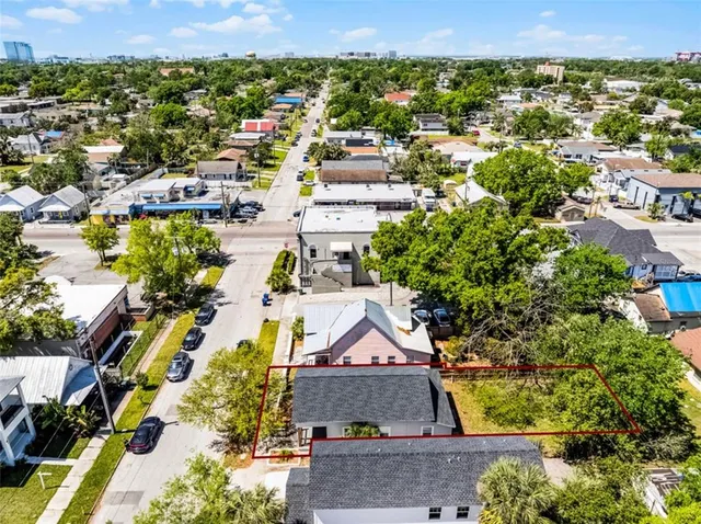 an aerial view of residential houses with outdoor space
