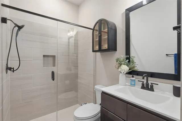 a bathroom with a sink toilet and shower