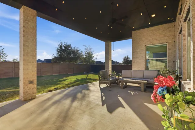 a front view of a house with a garden and a tree