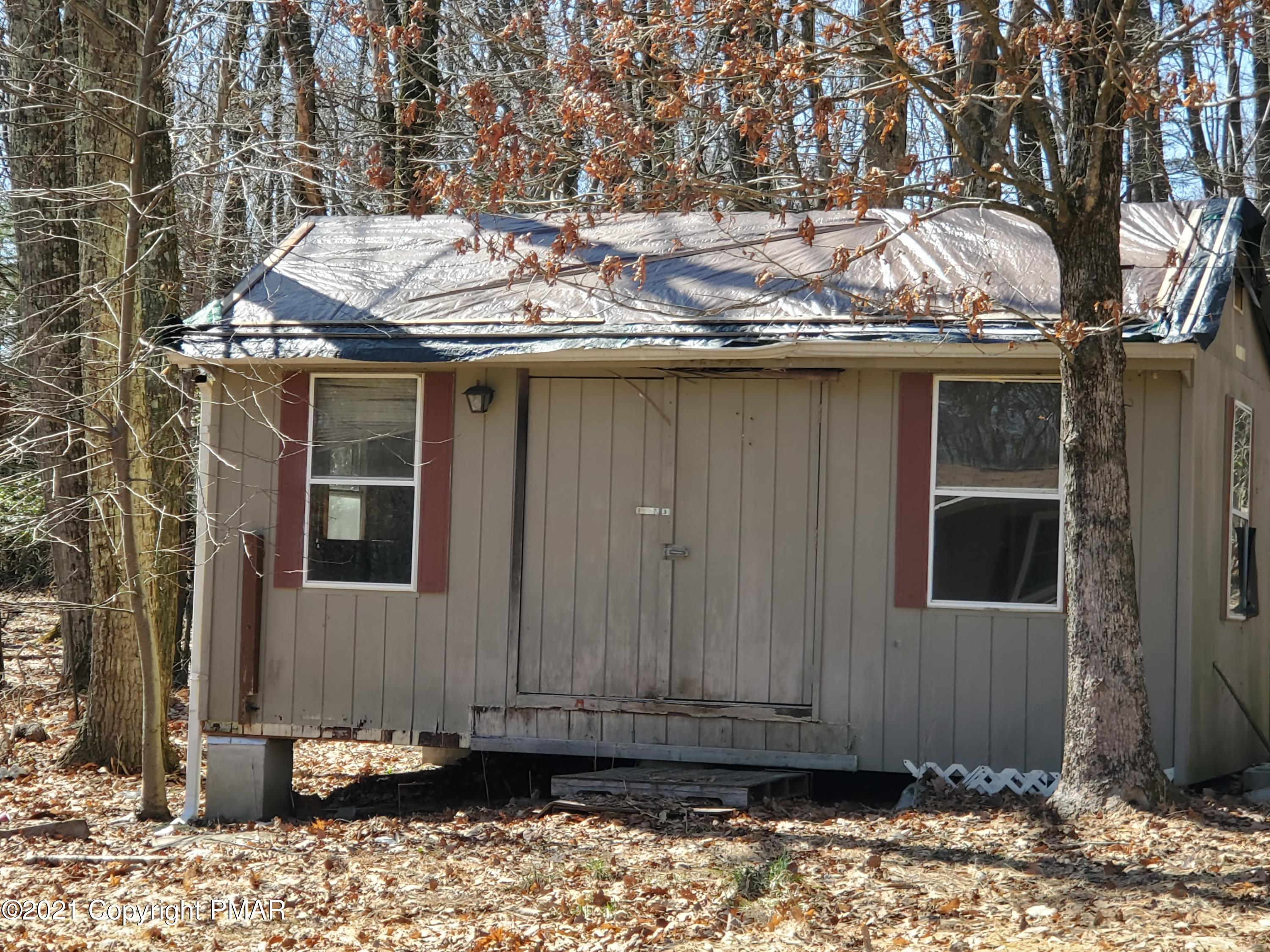 1112 Fir Road Effort, PA 18330 - Photo 7 of 8 a view of a house with a door and wooden fence