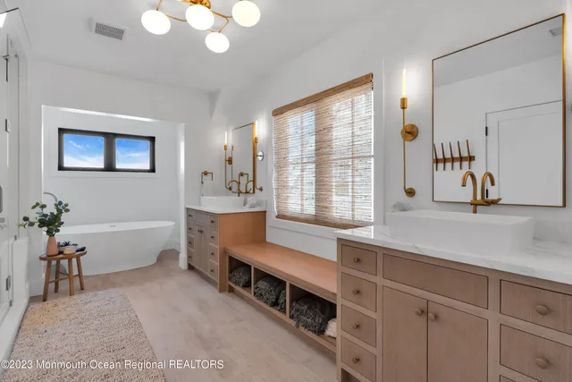 a bathroom with a sink a toilet and a mirror