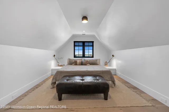 a view of a big house with a big yard and large trees