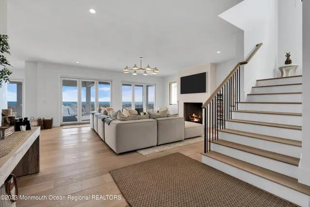 a living room with furniture and a chandelier