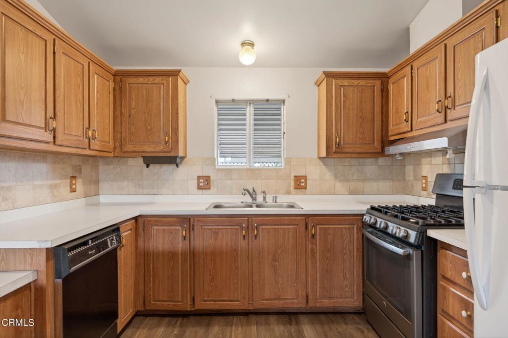 2177 Robin Avenue, Unit 2177A Oxnard, CA 93033 - Photo 13 of 28 a kitchen with stainless steel appliances granite countertop a sink stove and cabinets