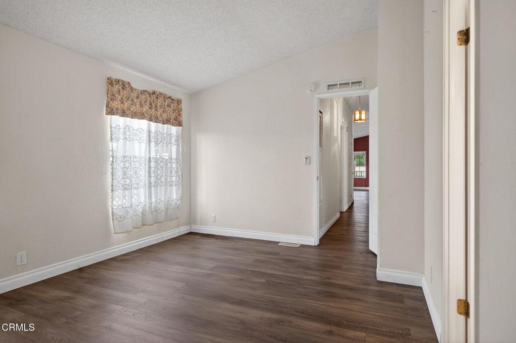 2177 Robin Avenue, Unit 2177A Oxnard, CA 93033 - Photo 21 of 28 an empty room with wooden floor and windows