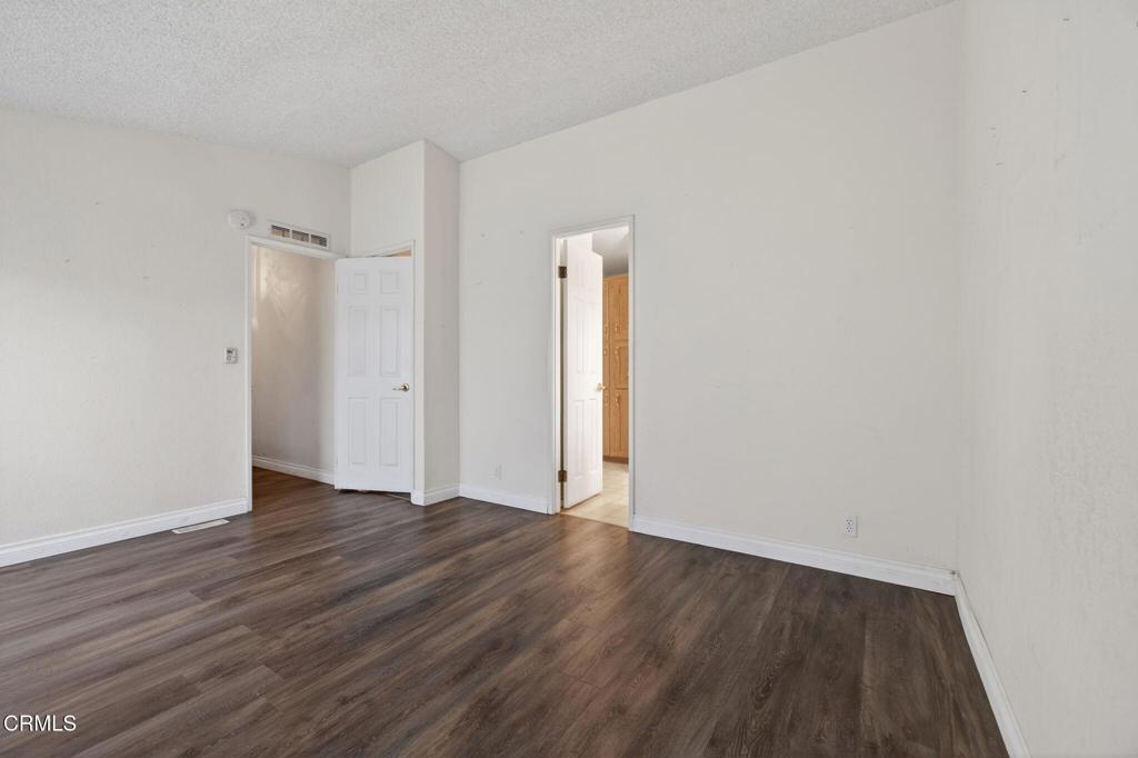 2177 Robin Avenue, Unit 2177A Oxnard, CA 93033 - Photo 22 of 28 an empty room with wooden floor and closet