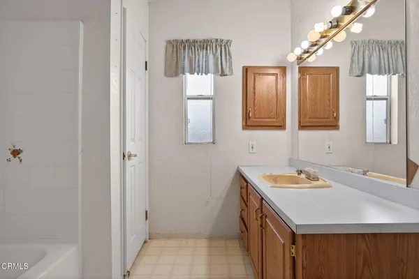 a bathroom with a sink a vanity and a mirror