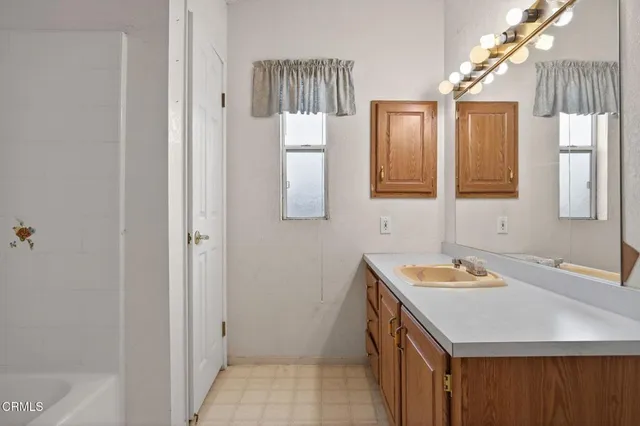 a bathroom with a sink a vanity and a mirror