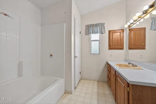 a bathroom with a sink a mirror and a bathtub