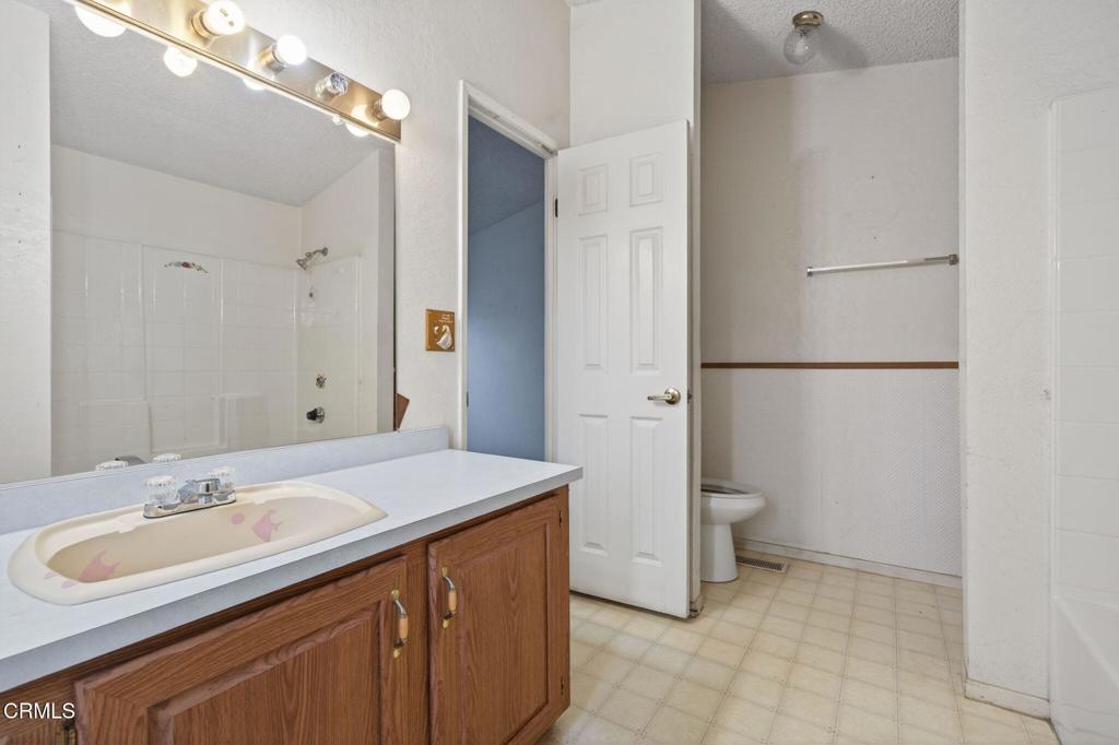 2177 Robin Avenue, Unit 2177A Oxnard, CA 93033 - Photo 25 of 28 a bathroom with a sink and a mirror