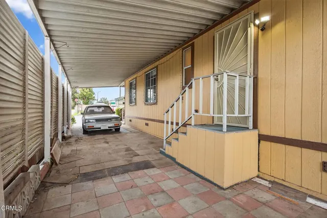 a view of a house with a car parked in the back