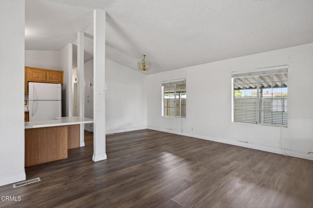 2177 Robin Avenue, Unit 2177A Oxnard, CA 93033 - Photo 8 of 28 an empty room with wooden floor and windows