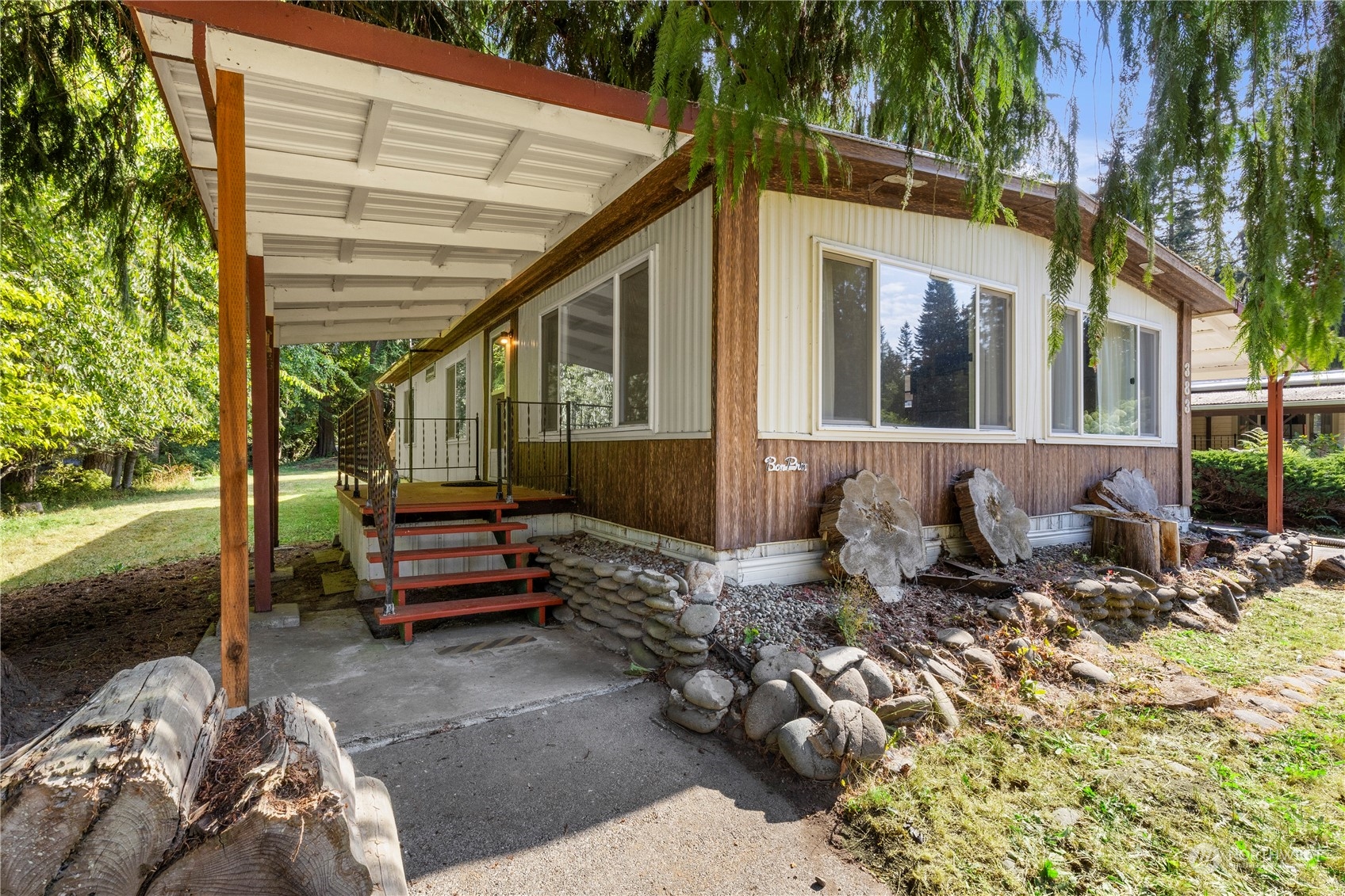 383 Dungeness Meadows Sequim, WA 98382 - Photo 1 of 30 a view of a patio with a table and chairs under an umbrella