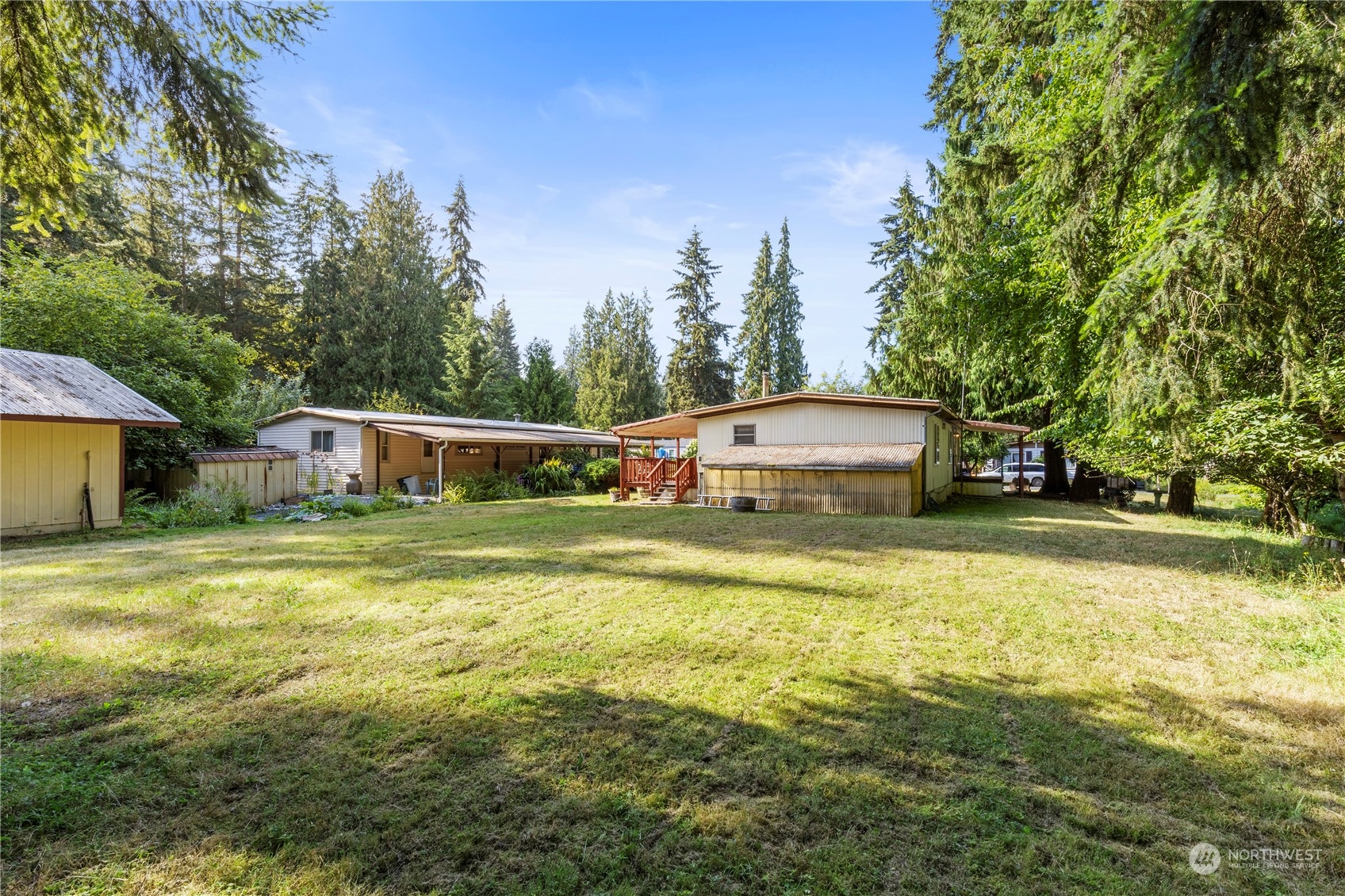 383 Dungeness Meadows Sequim, WA 98382 - Photo 19 of 30 a front view of a house with a yard and swimming pool