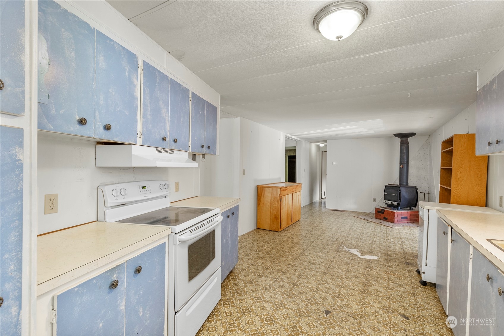 383 Dungeness Meadows Sequim, WA 98382 - Photo 6 of 30 a kitchen that has a lot of cabinets in it and wooden floors