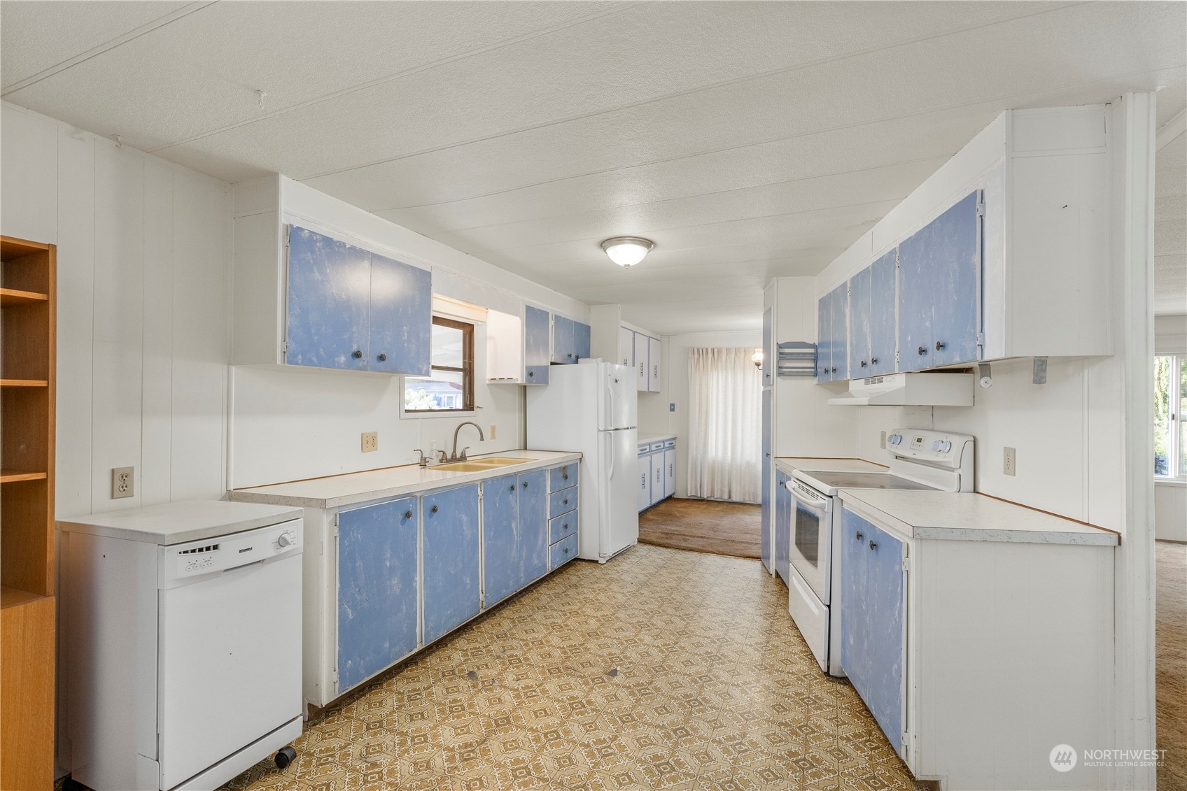 383 Dungeness Meadows Sequim, WA 98382 - Photo 7 of 30 a large kitchen with kitchen island a sink stainless steel appliances and cabinets