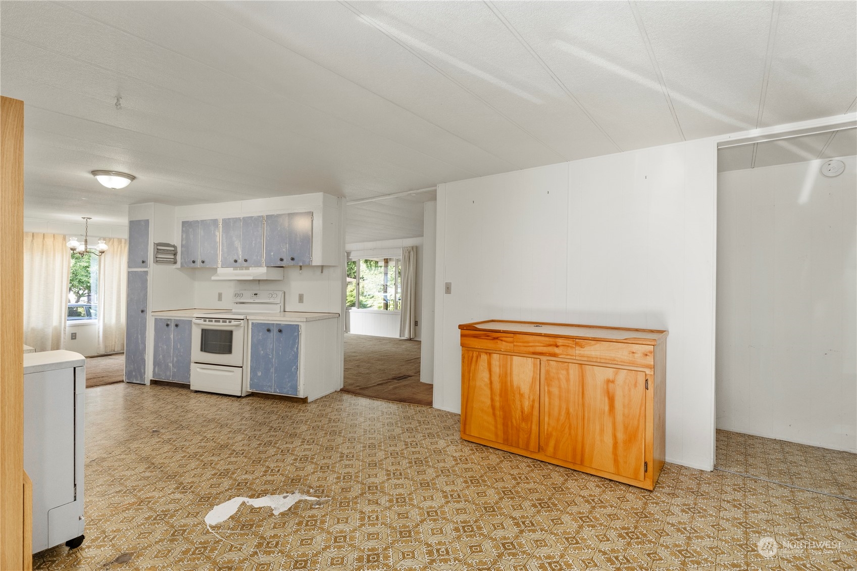 383 Dungeness Meadows Sequim, WA 98382 - Photo 9 of 30 a large white kitchen with stainless steel appliances kitchen island granite countertop a refrigerator and a stove top oven