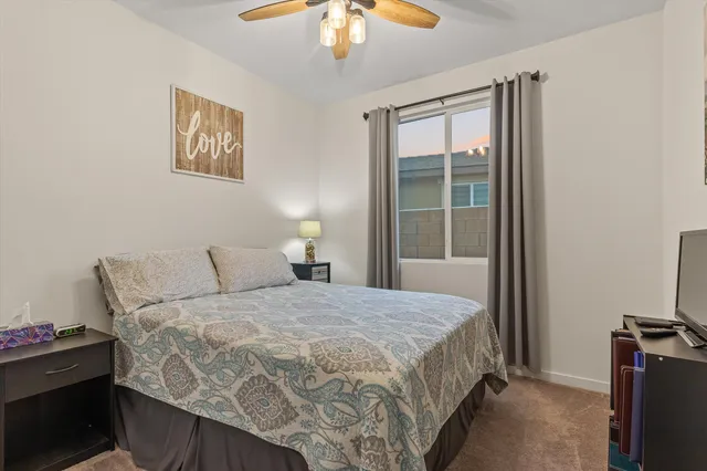a bedroom with a bed and a chandelier