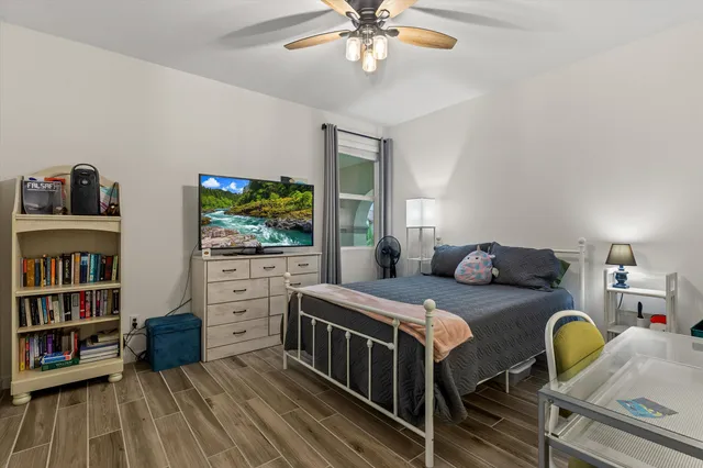 a bedroom with furniture and a flat screen tv
