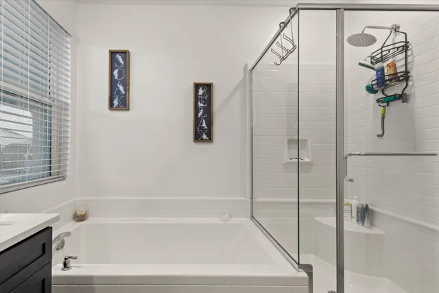 a bathroom with a bathtub and a shower
