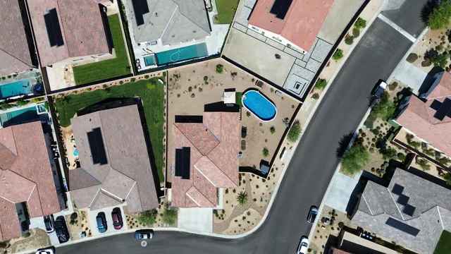 an aerial view of a house with a swimming pool
