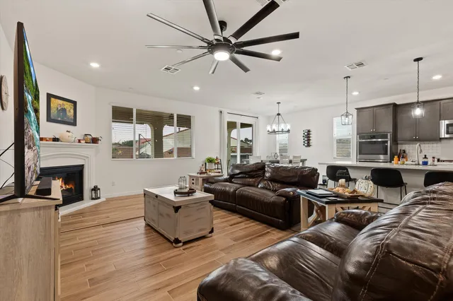 a living room with furniture kitchen view and a fireplace