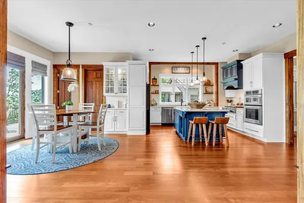 a living room with furniture a floor to ceiling window and a flat screen tv
