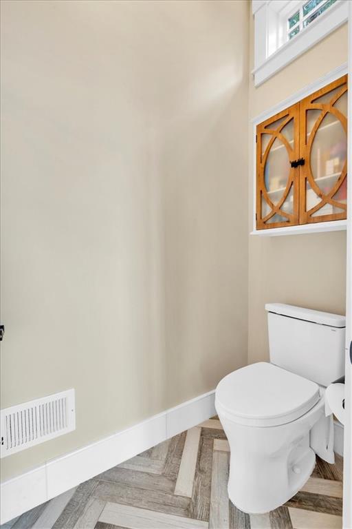 52 Waterside Drive Southeast Cartersville, GA 30121 - Photo 27 of 110 a white toilet sitting next to a shower curtain