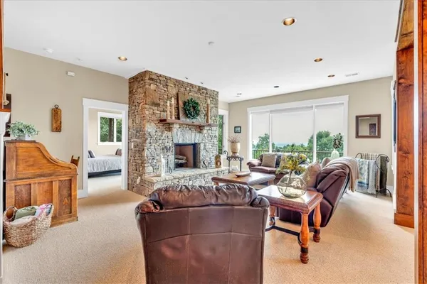a living room with furniture large window and a table