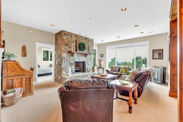 a living room with furniture large window and a table