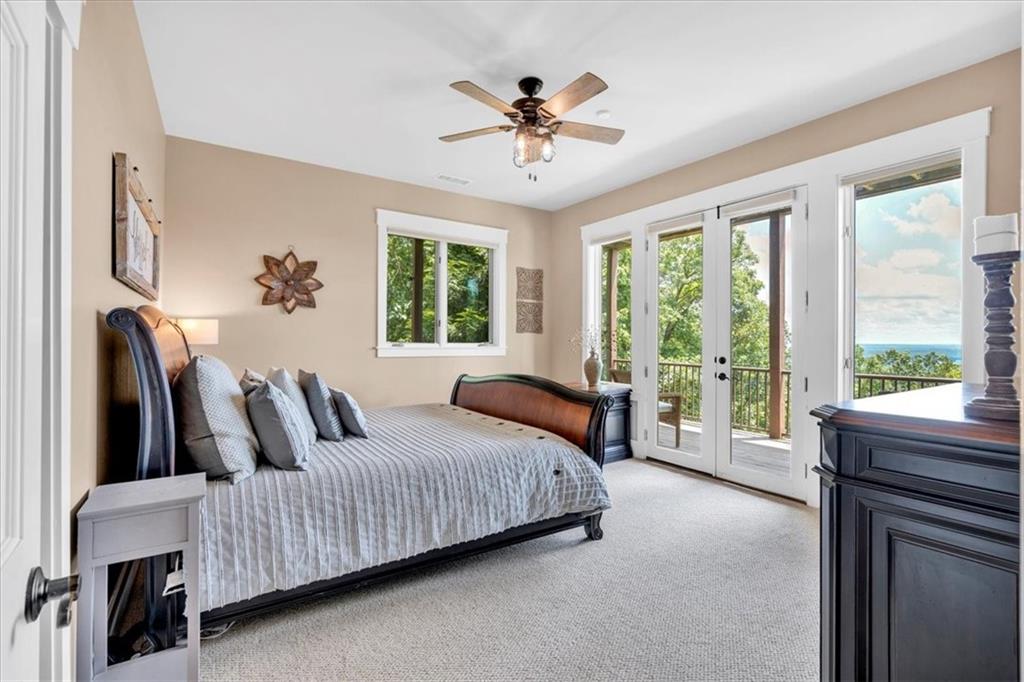 52 Waterside Drive Southeast Cartersville, GA 30121 - Photo 56 of 110 a bedroom with a large bed and a large window