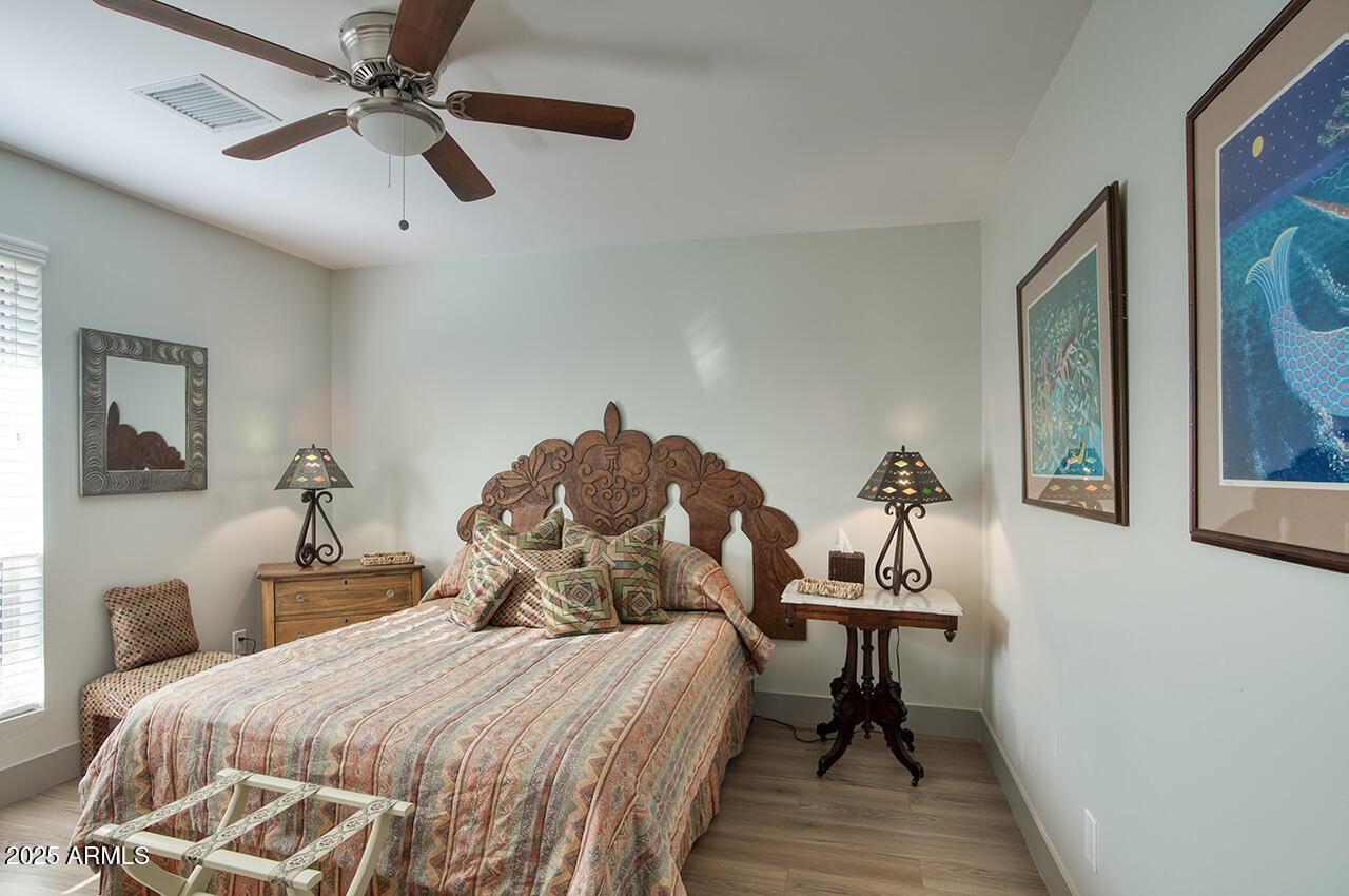 3337 East Las Rocas Drive Phoenix, AZ 85028 - Photo 17 of 22 a bedroom with a bed and a chandelier