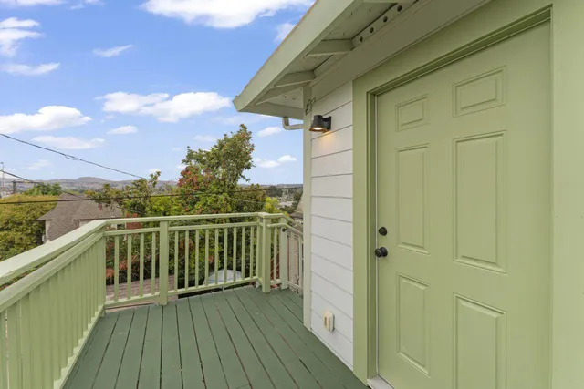 a view of balcony with wooden floor and fence