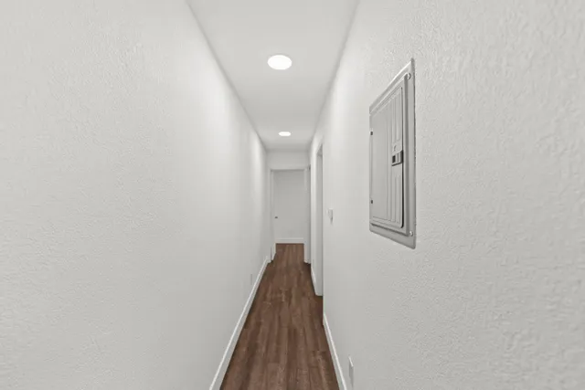a view of a hallway with wooden floor