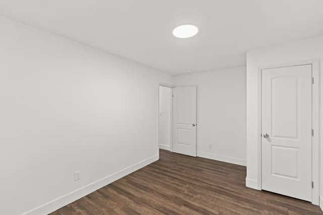 a view of an empty room and wooden floor