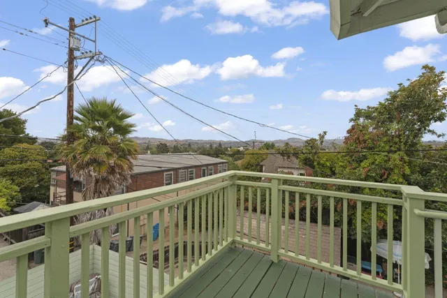 a view of a balcony with wooden floor