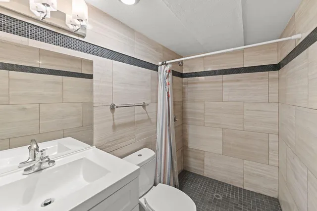 a bathroom with a sink toilet and shower