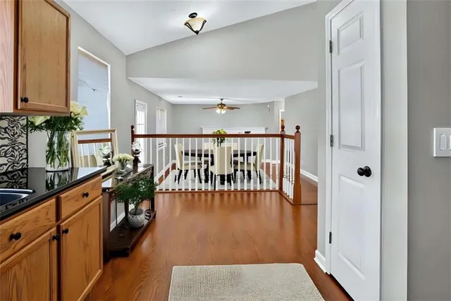 a hallway with wooden floor and windows