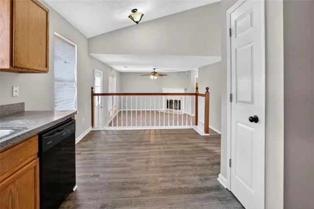 a view of a hallway with wooden floor and staircase