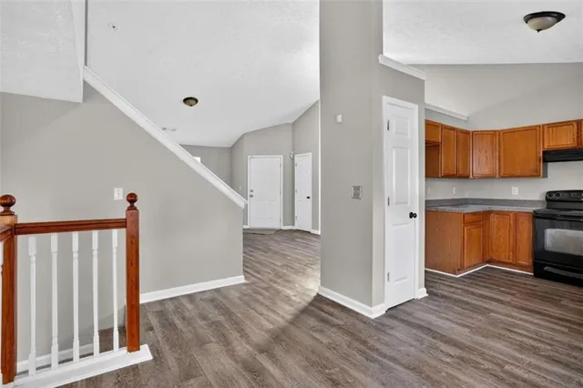 a view of kitchen with wooden floor and electronic appliances