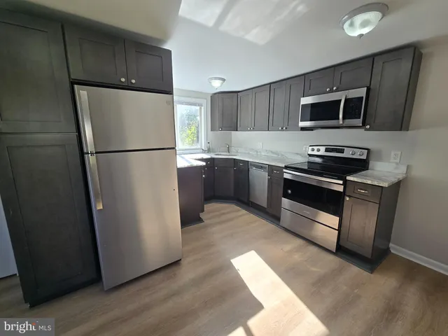 a kitchen with stainless steel appliances a refrigerator stove and microwave