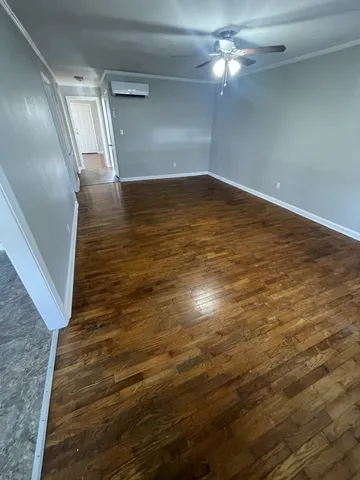 a view of empty room with wooden floor