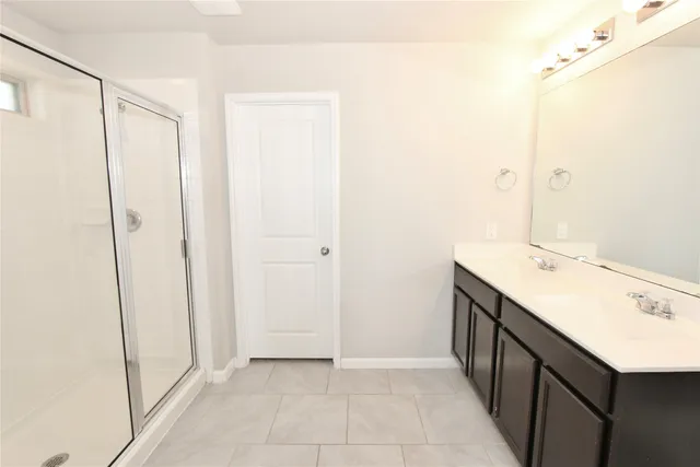 a bathroom with a sink a mirror and a shower