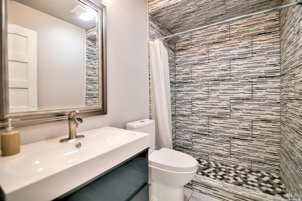 22 Fairfax Street, Unit B San Rafael, CA 94901 - Photo 5 of 8 a bathroom with a sink a toilet and mirror