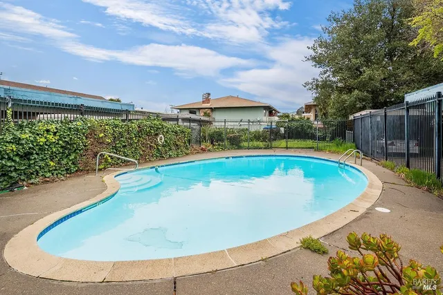 a view of swimming pool with outdoor seating and plants