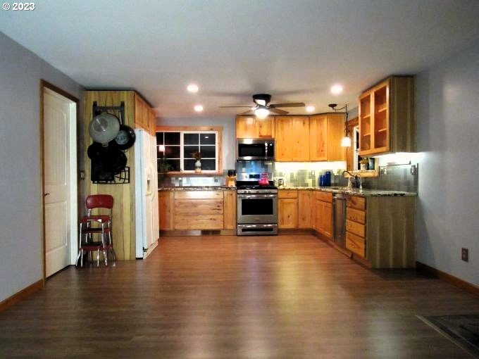 150 Southeast Palmblad Drive Gresham, OR 97080 - Photo 15 of 36 a kitchen with stainless steel appliances kitchen island granite countertop a refrigerator and a stove top oven