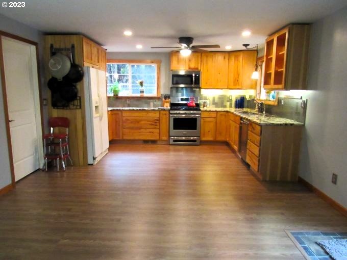 150 Southeast Palmblad Drive Gresham, OR 97080 - Photo 16 of 36 a kitchen with stainless steel appliances wooden floor sink and stove