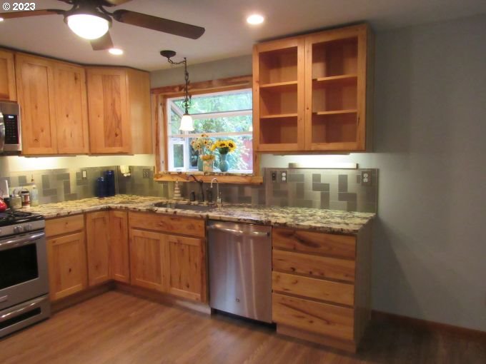 150 Southeast Palmblad Drive Gresham, OR 97080 - Photo 18 of 36 a kitchen with a sink window and cabinets